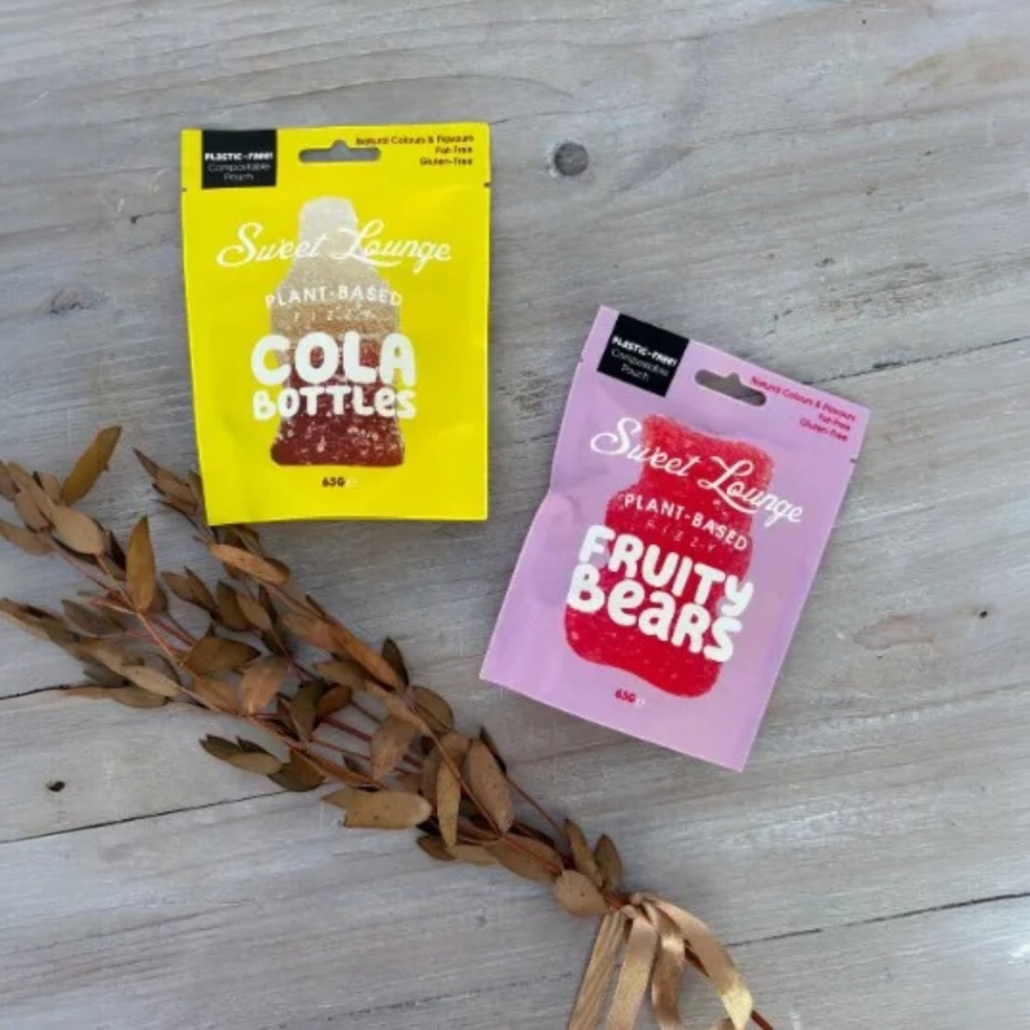 One Box of Peace gift box with plant-based cola bottles and fruity bears candy pouches.