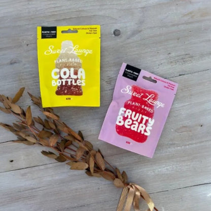 One Box of Peace gift box with plant-based cola bottles and fruity bears candy pouches.